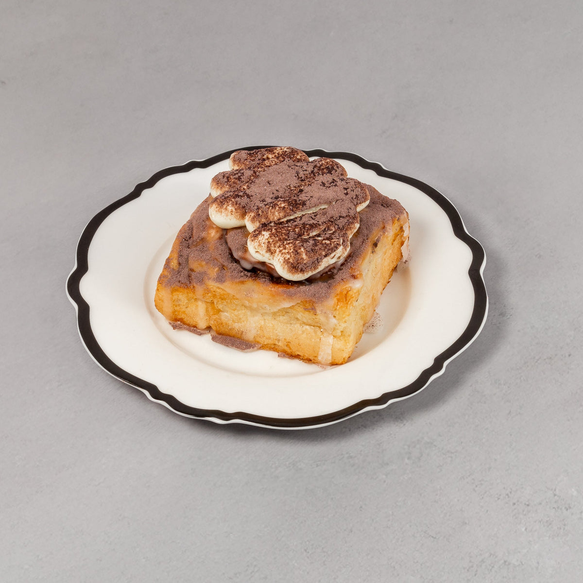 Small dish with a piece of bread topped with a slice of meat on a gray background