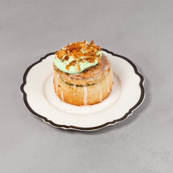 Small pastry on a decorative plate with a light gray background