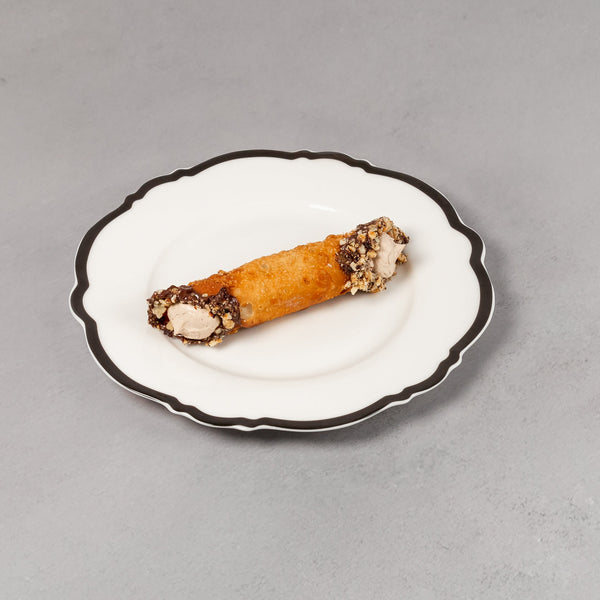 Small dish with a canape on a plain background